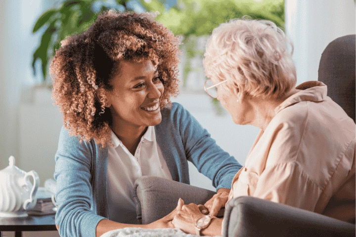 Caregiver providing companionship and supportive care to a senior in a warm, caring environment, ensuring emotional well-being.Caregiver providing companionship and supportive care to a senior in a warm, caring environment, ensuring emotional well-being.